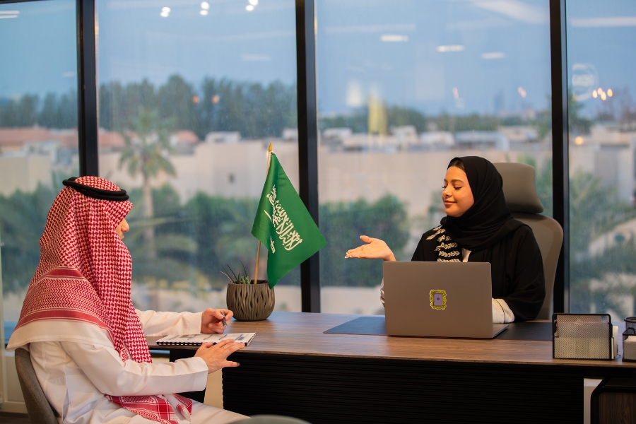 A Saudi national opening a Saudi bank account at a local bank branch.
