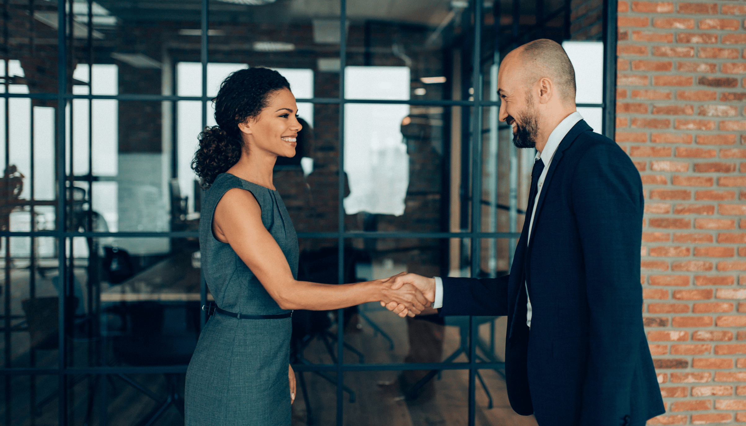 Professional handshake in a corporate setting, representing successful client relations and business partnerships.