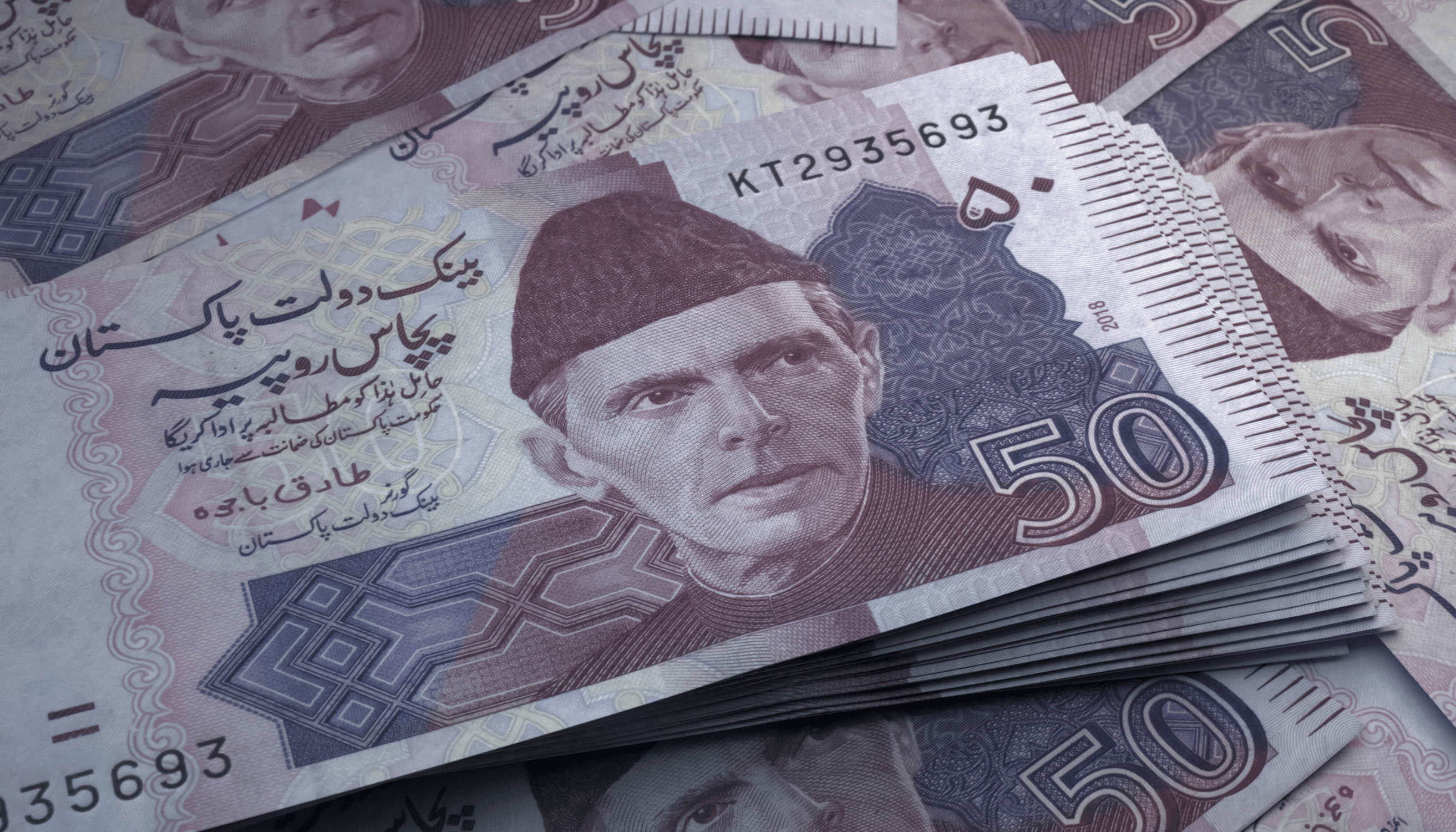 Close-up view of 50 Pakistani Rupee banknotes featuring the portrait of Quaid-e-Azam, symbolizing Pakistan's currency.